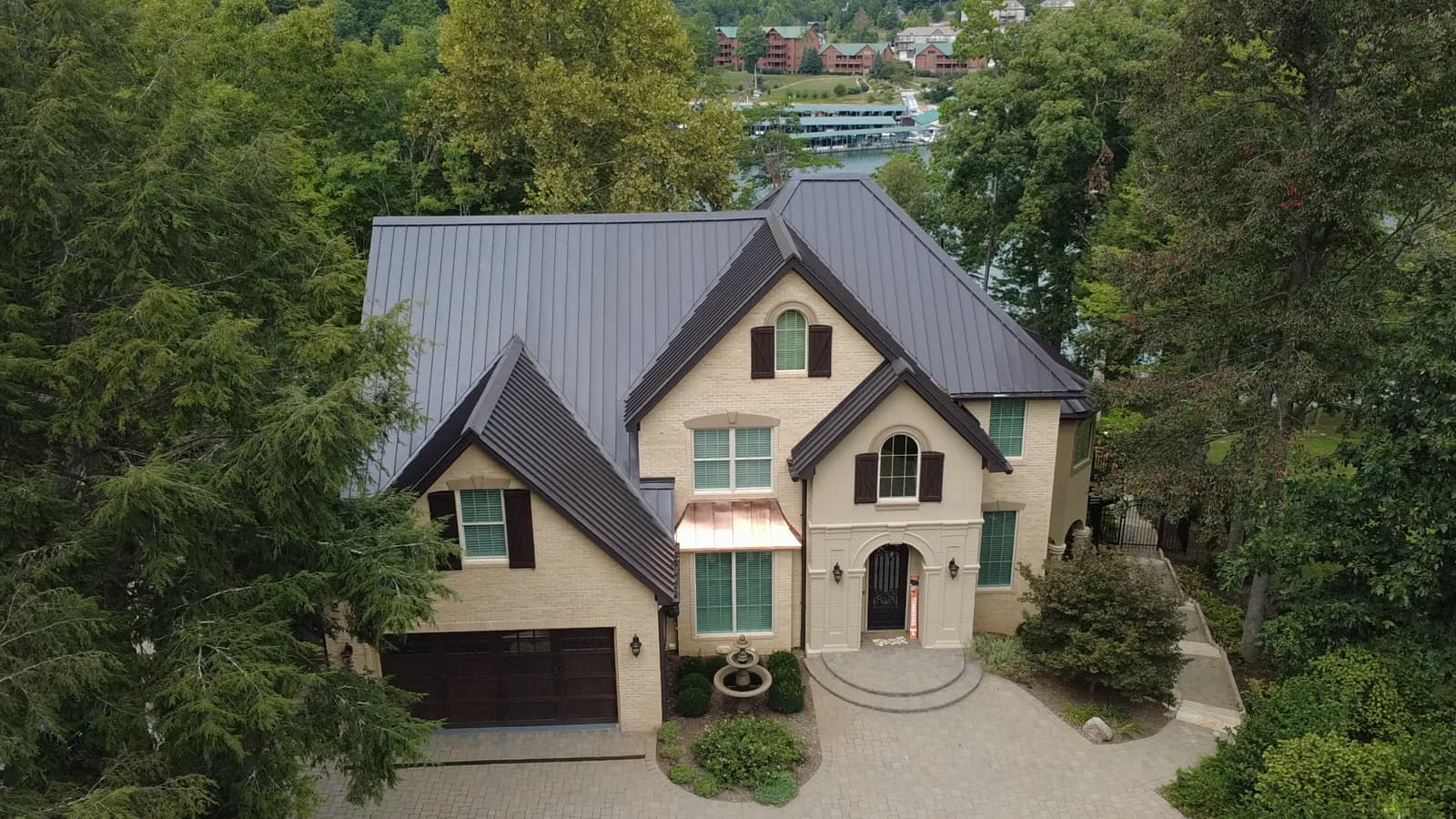 A drone view rising above a lake home to reveal the wooded shoreline and Norris Lake