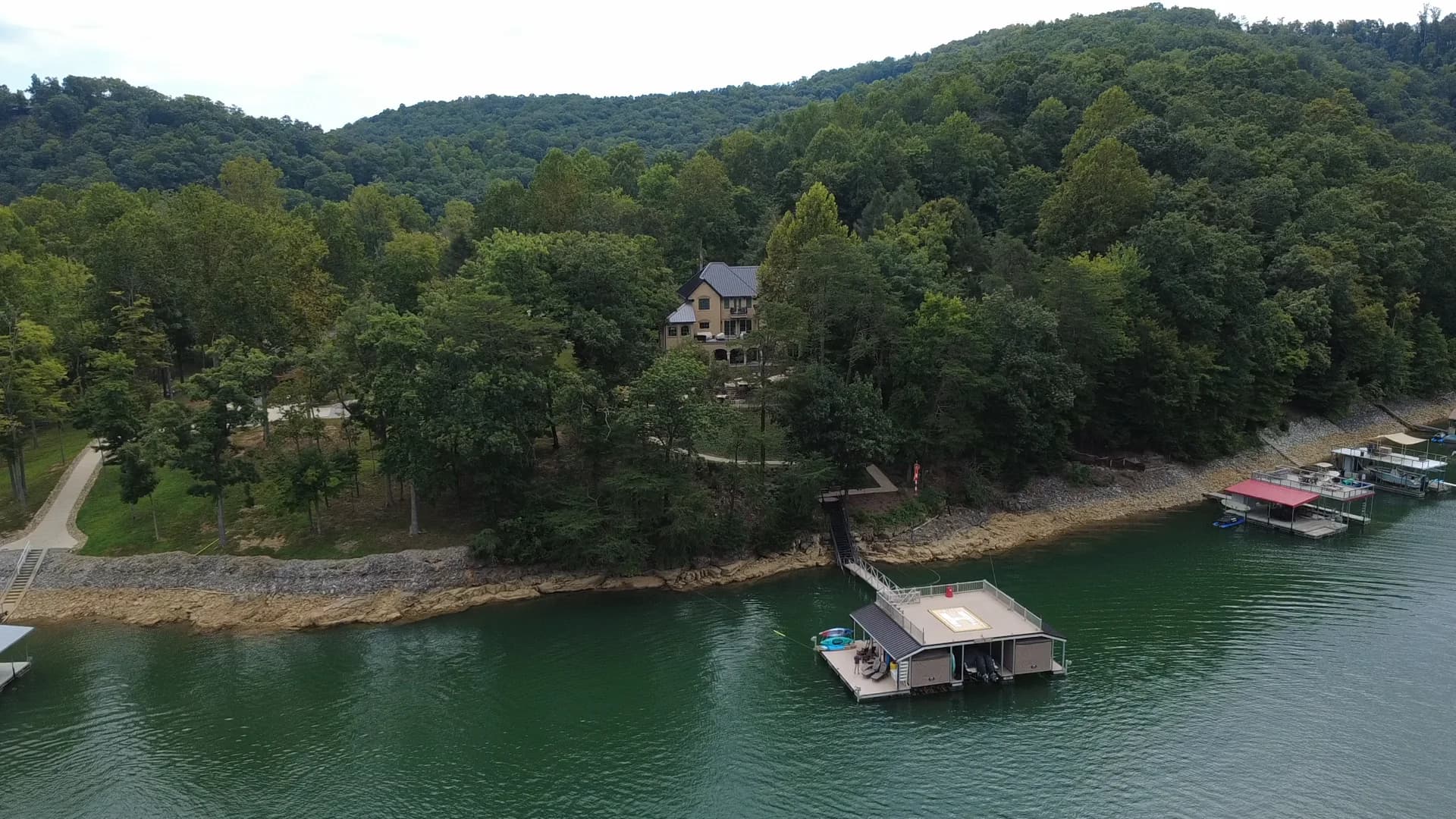 A wide view of Norris Lake, its wooded shoreline, and private docks